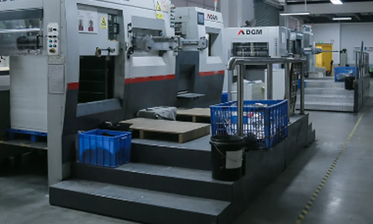 Die-cutting and finishing floor at a China factory producing custom cosmetic boxes, with DGM machines