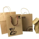 Custom kraft paper bags with logo print in natural brown, twisted handles, for wholesale food and retail packaging