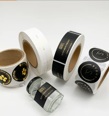 Custom paper label rolls with gold foil accents on glass jars, showing the labels, inks and adhesives assessed under California SB 343